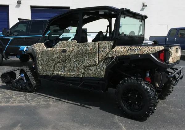 A Polaris General 4 Door side-by-side with a real tree duck hunt custom vinyl wrap.