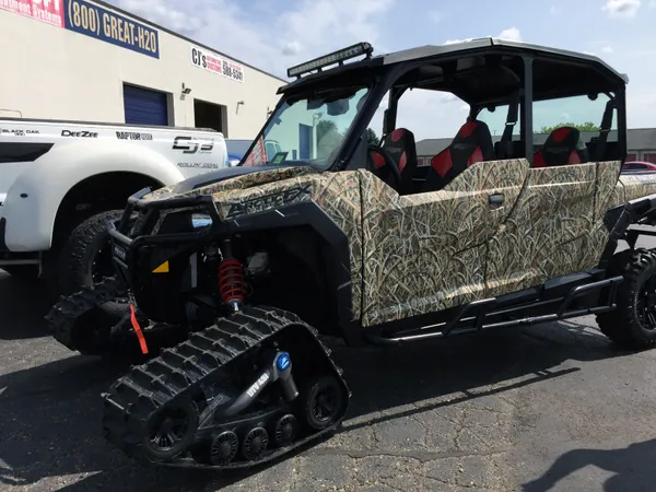 A Polaris General 4 Door side-by-side with a real tree duck hunt custom vinyl wrap.