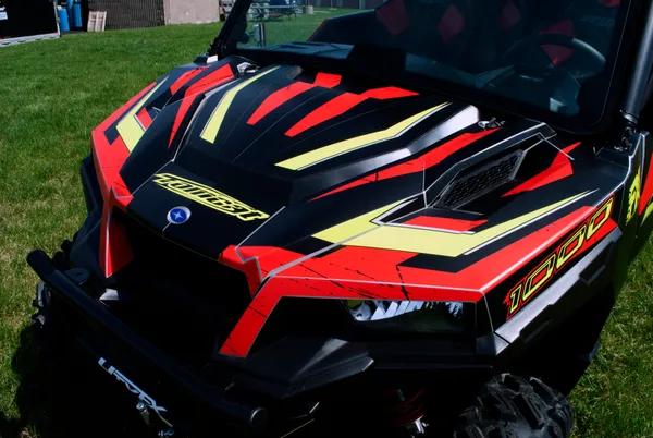 A Polaris General 4 Door side-by-side with a black, red and lime Rogue custom vinyl wrap.