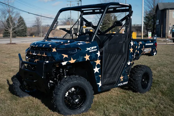 A Polaris Ranger 2 Door side-by-side with an American Rodeo custom vinyl wrap.