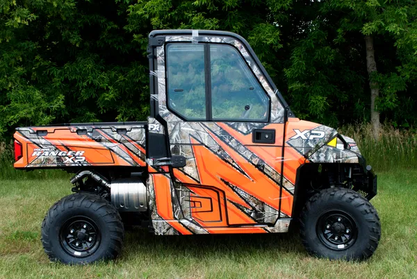 A Polaris Ranger 2 Door side-by-side with a orange and black real tree camo custom vinyl wrap.