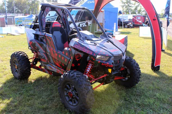 A Polaris RS1 side-by-side with a red, black, and gray American Flag custom vinyl wrap.