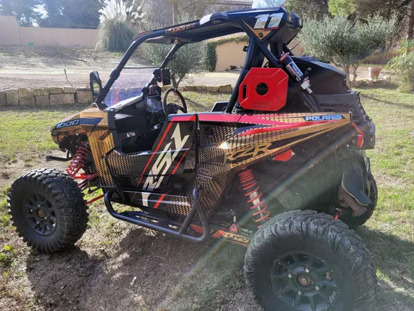 A Polaris RS1 side-by-side with a black, red and gold chrome custom vinyl wrap.