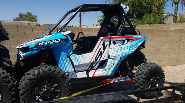 A Polaris RS1 side-by-side with a red, white and blue custom vinyl wrap.
