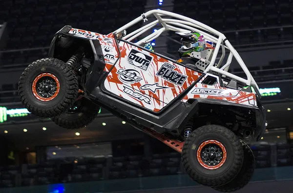 A Polaris RZR 2 Door side-by-side with a red and whiteJimmy Blaze custom vinyl wrap.
