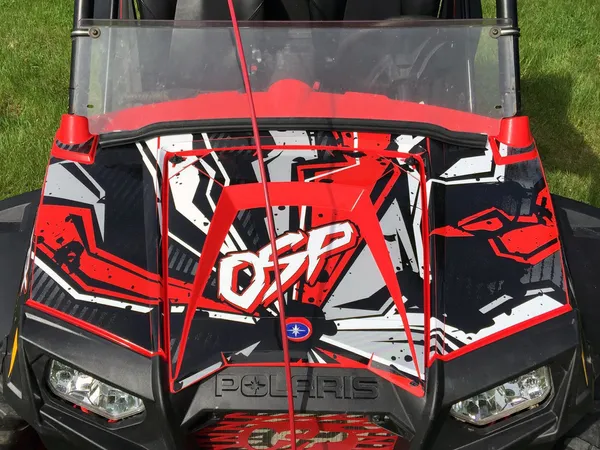 A Polaris RZR 2 Door side-by-side with a red and white Stricken custom vinyl wrap.