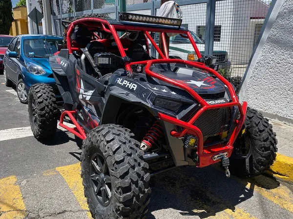 A Polaris RZR XP 2 Door 2018+ side-by-side with a red, black, and gray grunge Wartorn custom vinyl wrap.