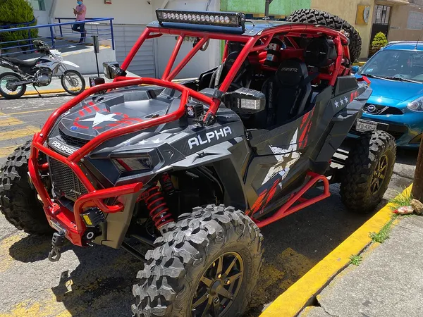 A Polaris RZR XP 2 Door 2018+ side-by-side with a red, black, and gray grunge Wartorn custom vinyl wrap.