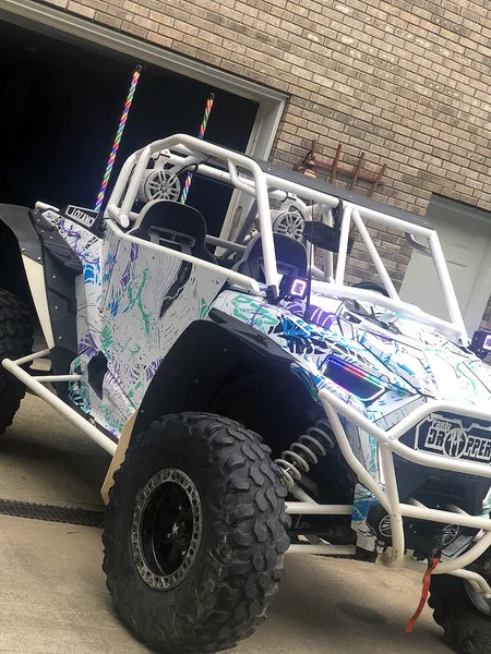 A Polaris RZR XP 2 Door 2018+ side-by-side with a white, blue, and purple sketch grunge Wicked custom vinyl wrap.