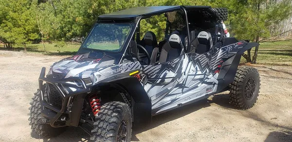 A Polaris RZR XP 4 Door 2018+ side-by-side with a black and gray grunge mountain Altitude custom vinyl wrap.