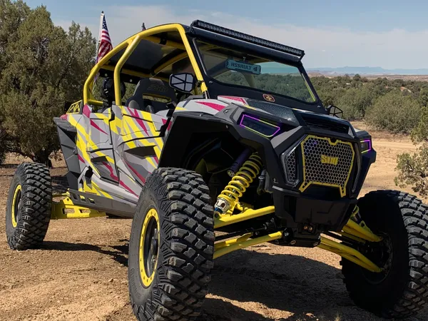 A Polaris RZR XP 4 Door 2018+ side-by-side with a gray, lime squeeze, and burgundy stripes Evolution custom vinyl wrap.
