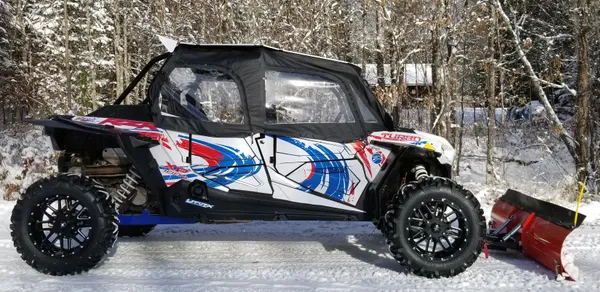 A Polaris RZR XP 4 Door 2018+ side-by-side with a red, white, and blue grunge swirl Surge custom vinyl wrap.