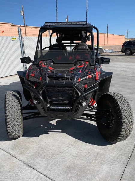 A Polaris RZR XP 4 Door 2018+ side-by-side with a red, gray, and black geometric pattern Virus custom vinyl wrap.