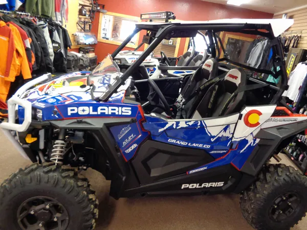 A Polaris RZR XP 2 Door side-by-side with a red, blue, and white Colorado Spirt Lake custom vinyl wrap.