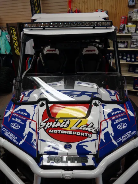 A Polaris RZR XP 2 Door side-by-side with a red, blue, and white Colorado Spirt Lake custom vinyl wrap.